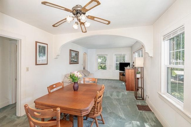 4528 30th Ave S, Minneapolis, MN 55406 - dining space with arched walkways, carpet floors, and healthy amount of natural light