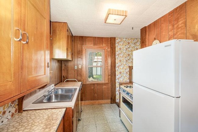 4528 30th Ave S, Minneapolis, MN 55406 - kitchen with freestanding refrigerator, gas range, brown cabinetry, light floors, and light countertops