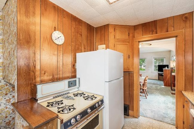 4528 30th Ave S, Minneapolis, MN 55406 - kitchen featuring white appliances, wooden walls, brown cabinets, and light countertops