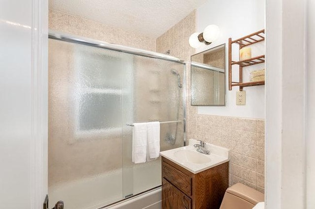 4528 30th Ave S, Minneapolis, MN 55406 - bathroom featuring vanity, bath / shower combo with glass door, and tile walls