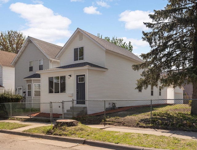view of front of house with a fenced front yard, a shingled roof, and entry steps