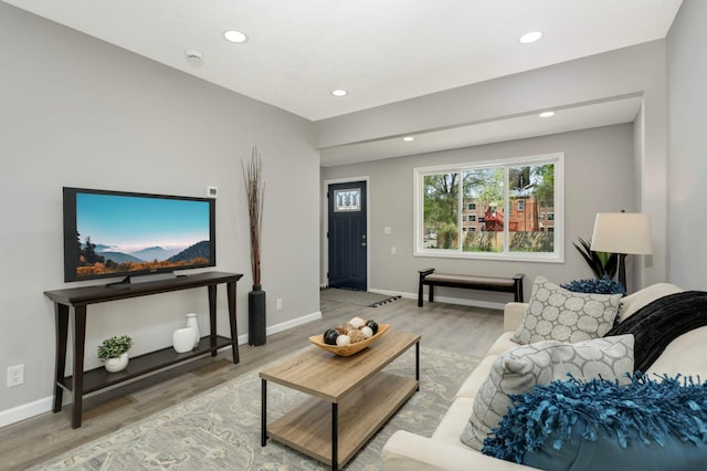 living room with wood finished floors, recessed lighting, and baseboards