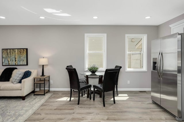 dining room with light wood-style floors, baseboards, and recessed lighting
