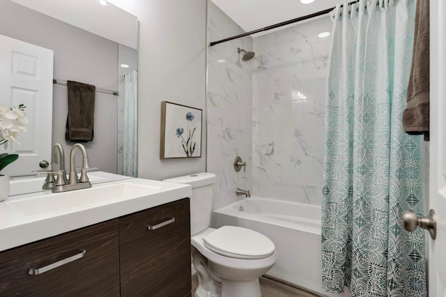 bathroom featuring shower / tub combo, toilet, and vanity