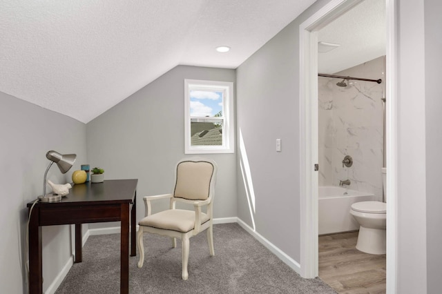 office space featuring a textured ceiling, lofted ceiling, and baseboards