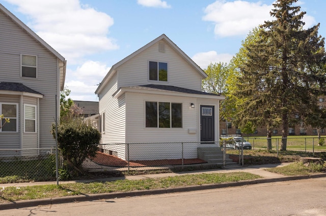 view of front of home with a fenced front yard and entry steps