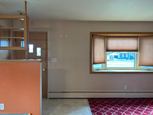 foyer entrance with a baseboard radiator and baseboards
