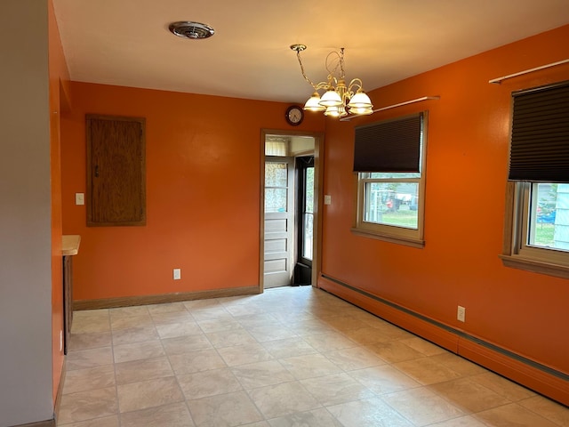 unfurnished room featuring a baseboard radiator, baseboards, a healthy amount of sunlight, and an inviting chandelier