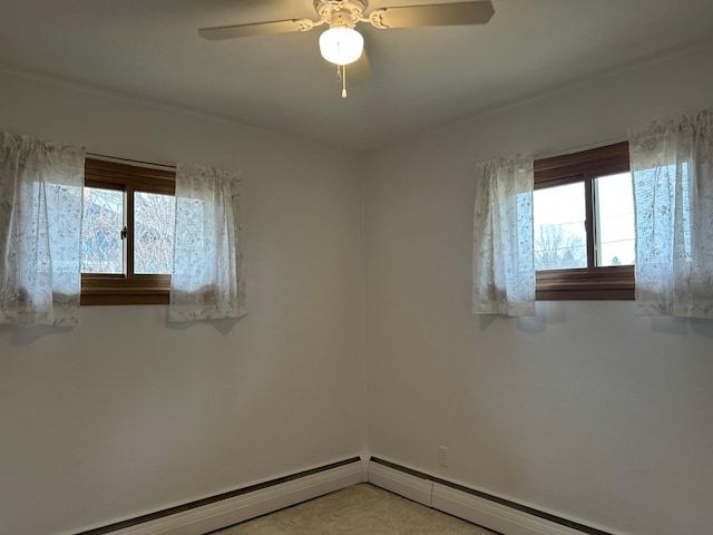 spare room featuring baseboard heating, ceiling fan, and plenty of natural light