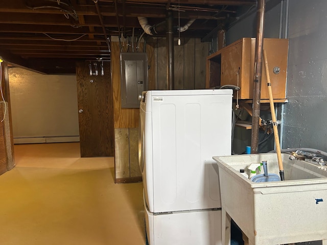 laundry area with a sink, laundry area, electric panel, washer / dryer, and a baseboard radiator