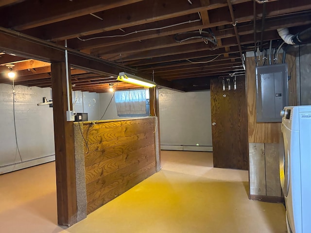 unfinished basement with a baseboard heating unit, a baseboard radiator, washer / dryer, and electric panel