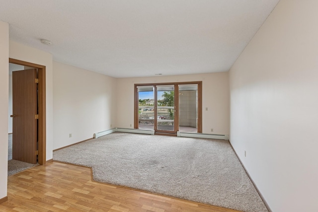 14575 Burma Ave W Unit 202, Rosemount, MN 55068 - unfurnished room featuring a baseboard heating unit, a smoke detector, light wood-style flooring, and baseboards