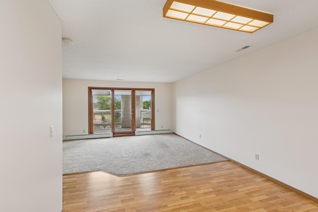 14575 Burma Ave W Unit 202, Rosemount, MN 55068 - spare room featuring a baseboard radiator, light wood-style flooring, and baseboards