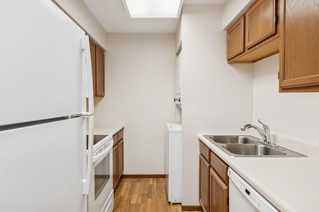 14575 Burma Ave W Unit 202, Rosemount, MN 55068 - kitchen with white appliances, a sink, light wood finished floors, light countertops, and washer / clothes dryer