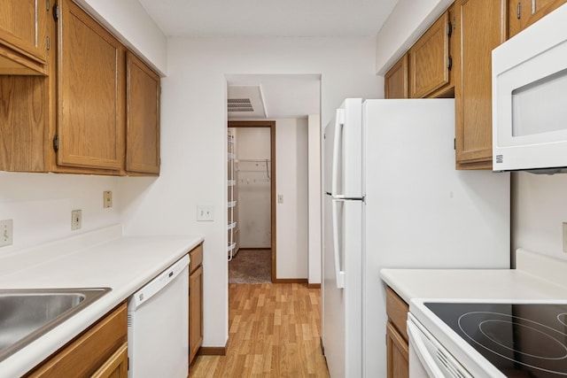 14575 Burma Ave W Unit 202, Rosemount, MN 55068 - kitchen featuring white appliances, light wood-style floors, brown cabinets, light countertops, and baseboards