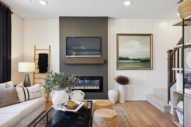 15071 Athgoe Dr, Rosemount, MN 55068 - living room featuring wood finished floors, stairs, a glass covered fireplace, recessed lighting, and baseboards