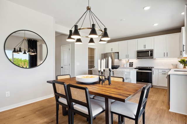 15071 Athgoe Dr, Rosemount, MN 55068 - dining room featuring a chandelier, baseboards, light wood finished floors, and recessed lighting