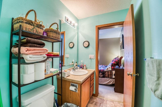 16693 Hightop Way NW, Cass Lake, MN 56633 - ensuite bathroom with vanity, toilet, and a textured ceiling