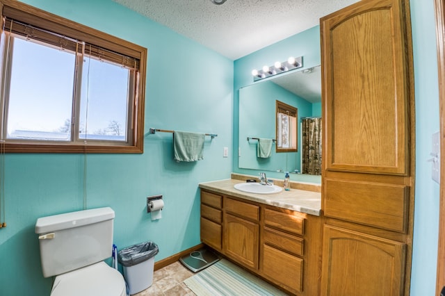 16693 Hightop Way NW, Cass Lake, MN 56633 - full bath with toilet, vanity, baseboards, and a textured ceiling