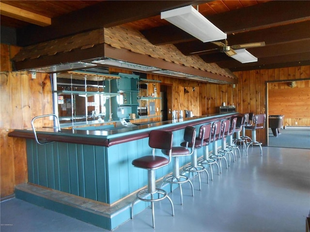 16693 Hightop Way NW, Cass Lake, MN 56633 - kitchen featuring wooden walls, beamed ceiling, a ceiling fan, and concrete floors