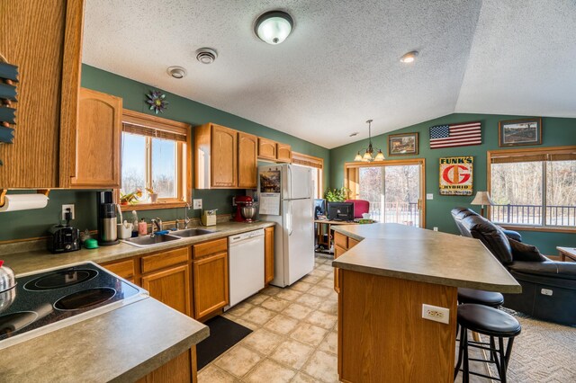 16693 Hightop Way NW, Cass Lake, MN 56633 - kitchen featuring white appliances, a sink, lofted ceiling, plenty of natural light, and a textured ceiling