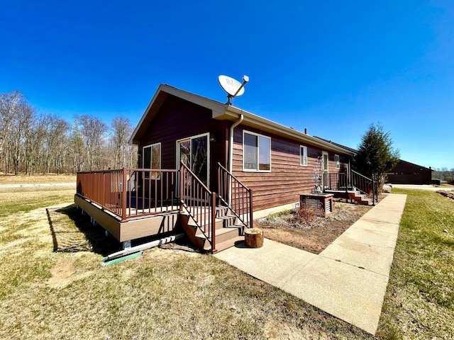 16693 Hightop Way NW, Cass Lake, MN 56633 - view of home's exterior featuring a yard and a deck
