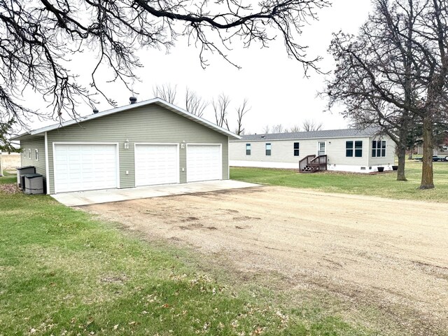 detached garage with dirt driveway