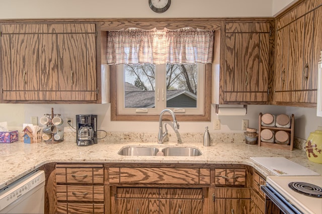 36 Ben Nevis Ln, Waite Park, MN 56387 - kitchen featuring a sink, light stone counters, brown cabinets, and dishwasher