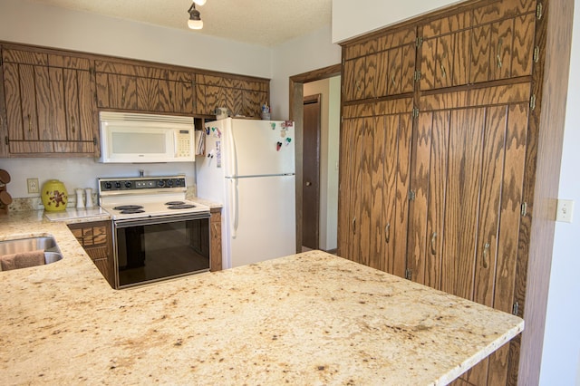 36 Ben Nevis Ln, Waite Park, MN 56387 - kitchen featuring a peninsula, white appliances, a textured ceiling, light stone counters, and a sink