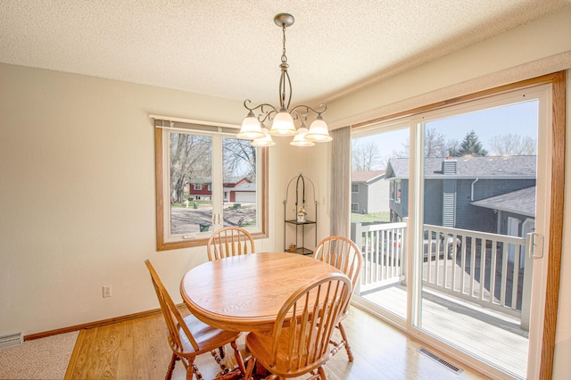 36 Ben Nevis Ln, Waite Park, MN 56387 - dining space featuring visible vents, a textured ceiling, plenty of natural light, and a notable chandelier