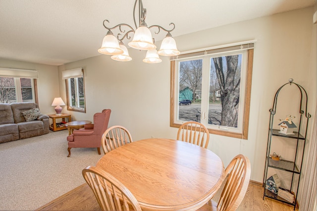 36 Ben Nevis Ln, Waite Park, MN 56387 - dining area featuring light wood-style floors, a chandelier, and a wealth of natural light