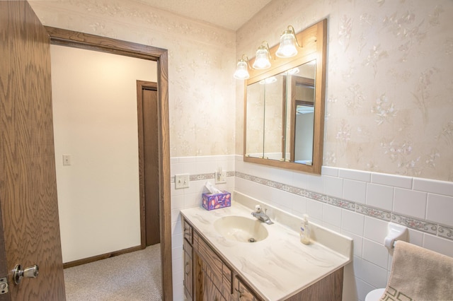 36 Ben Nevis Ln, Waite Park, MN 56387 - half bath with wallpapered walls, tile walls, wainscoting, and vanity