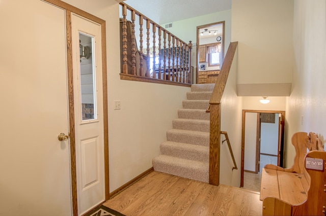 36 Ben Nevis Ln, Waite Park, MN 56387 - staircase with visible vents, baseboards, and wood finished floors