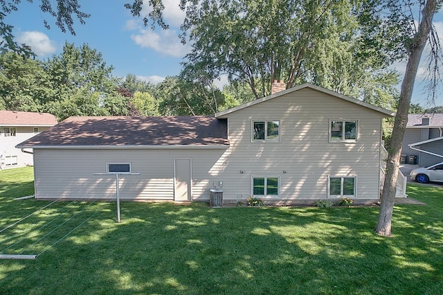 36 Ben Nevis Ln, Waite Park, MN 56387 - back of house featuring a yard and a chimney