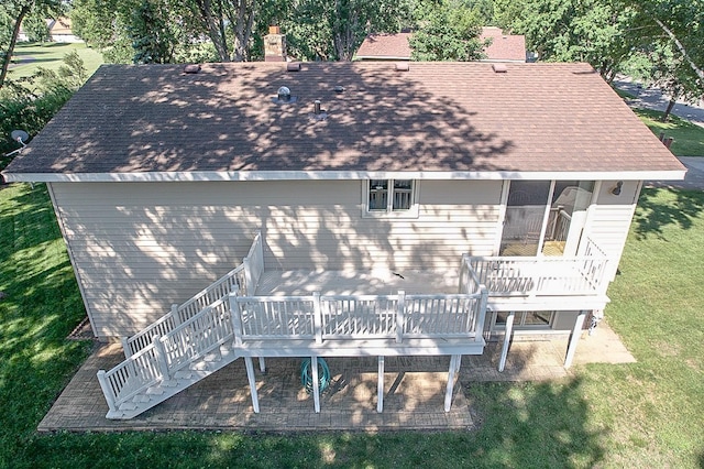 36 Ben Nevis Ln, Waite Park, MN 56387 - back of property featuring roof with shingles, stairs, a wooden deck, and a chimney