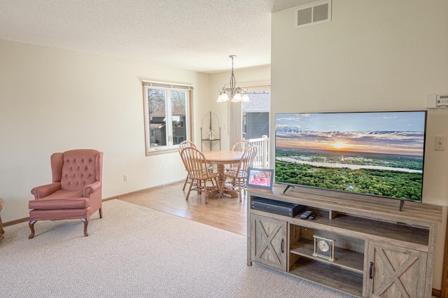 36 Ben Nevis Ln, Waite Park, MN 56387 - carpeted living area with a chandelier and a textured ceiling