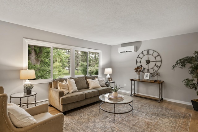 21485 Inwood Ave N, Forest Lake, MN 55025 - living room with a wall mounted AC, wood finished floors, a textured ceiling, and baseboards