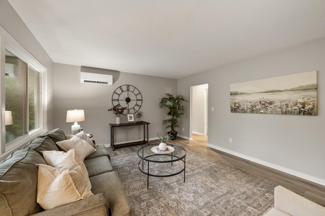 21485 Inwood Ave N, Forest Lake, MN 55025 - living area with an AC wall unit, wood finished floors, baseboards, and a wall mounted AC