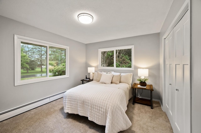 21485 Inwood Ave N, Forest Lake, MN 55025 - bedroom featuring baseboard heating, multiple windows, carpet flooring, and a closet