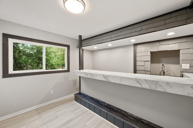 21485 Inwood Ave N, Forest Lake, MN 55025 - bar area with baseboards, a textured ceiling, a sink, and recessed lighting