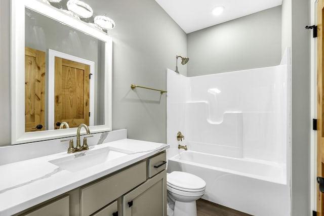 25882 Emerson Ct, Wyoming, MN 55092 - bathroom featuring vanity, toilet, wood finished floors, and shower / bathing tub combination