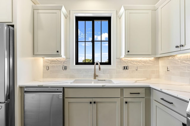 25882 Emerson Ct, Wyoming, MN 55092 - kitchen with light stone counters, decorative backsplash, appliances with stainless steel finishes, and a sink