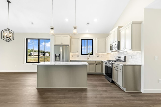 25882 Emerson Ct, Wyoming, MN 55092 - kitchen with baseboards, backsplash, light countertops, a kitchen island, and appliances with stainless steel finishes