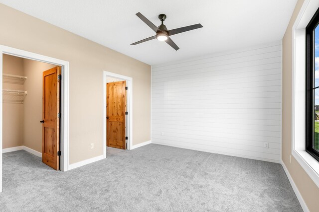 25882 Emerson Ct, Wyoming, MN 55092 - unfurnished bedroom with a closet, a ceiling fan, a spacious closet, and carpet floors
