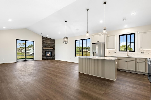 25882 Emerson Ct, Wyoming, MN 55092 - kitchen featuring a healthy amount of sunlight, stainless steel fridge, a sink, and a kitchen island