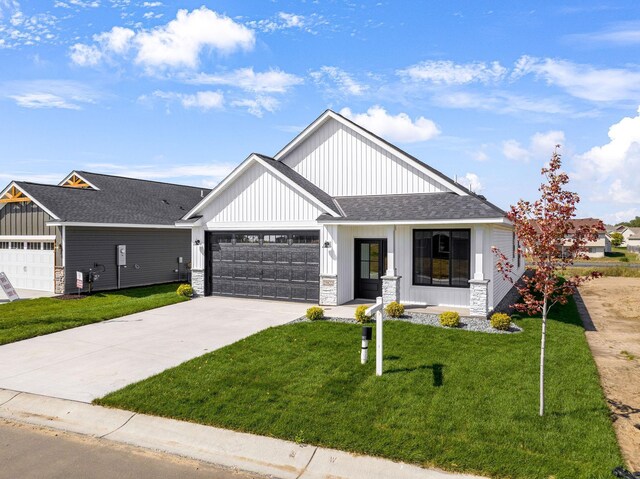 25882 Emerson Ct, Wyoming, MN 55092 - modern inspired farmhouse featuring a front lawn, a shingled roof, an attached garage, and concrete driveway