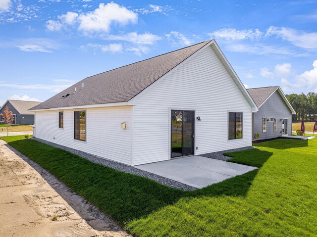 25882 Emerson Ct, Wyoming, MN 55092 - back of property with a lawn, a patio area, and roof with shingles