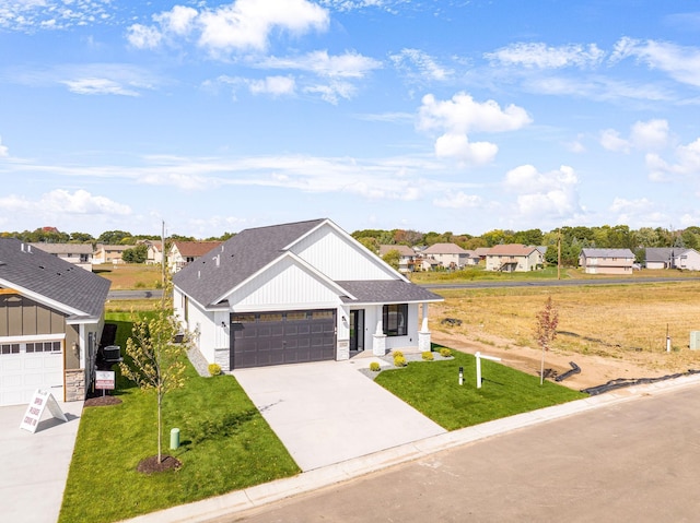 25882 Emerson Ct, Wyoming, MN 55092 - modern farmhouse style home featuring a garage, a shingled roof, a front lawn, and a residential view