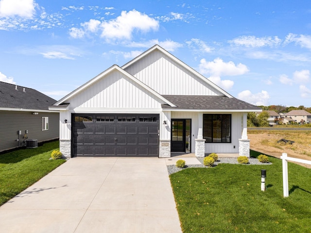 25882 Emerson Ct, Wyoming, MN 55092 - modern farmhouse with concrete driveway, an attached garage, a front lawn, and stone siding