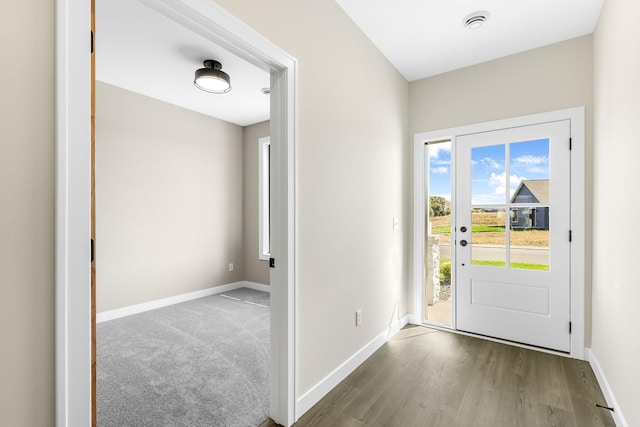 25882 Emerson Ct, Wyoming, MN 55092 - doorway to outside featuring wood finished floors, visible vents, and baseboards